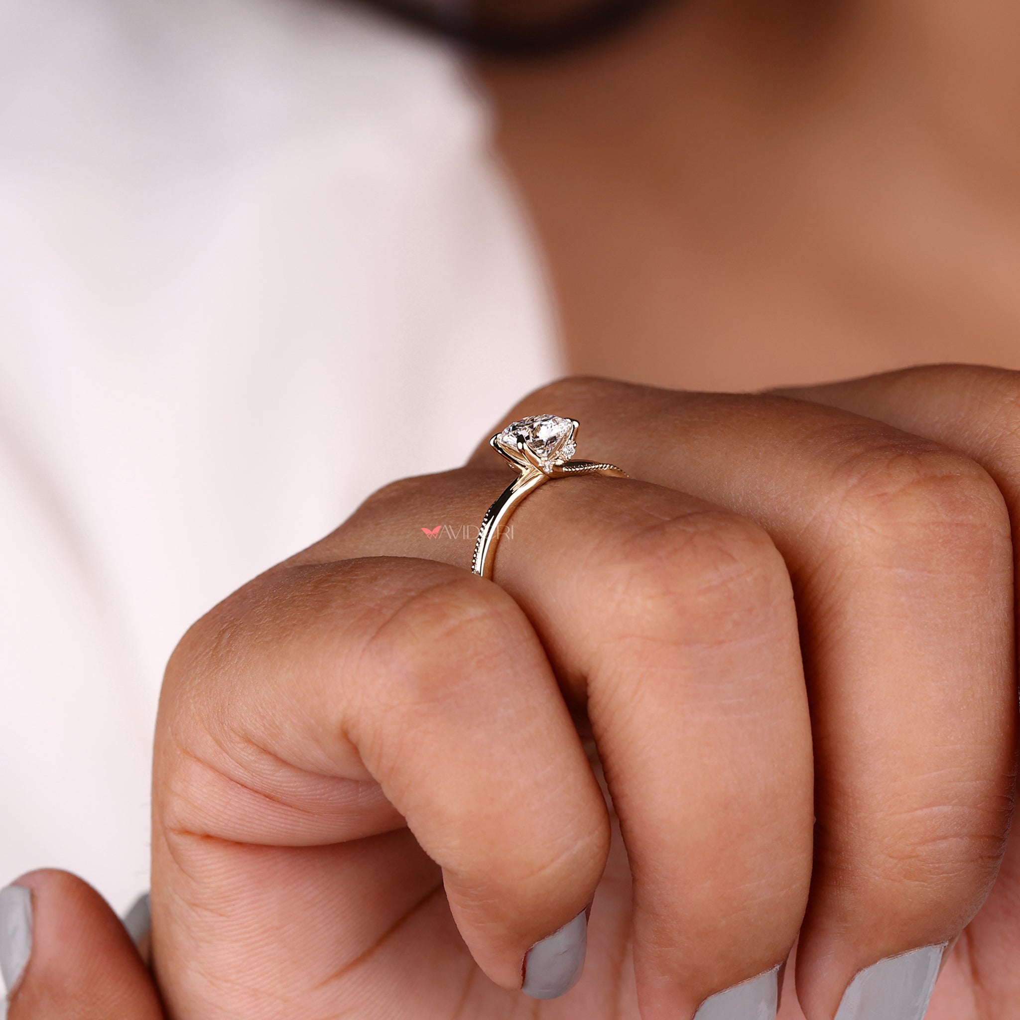 Lab diamond engagement ring with intricate milgrain details in a gold solitaire engagement ring design.
