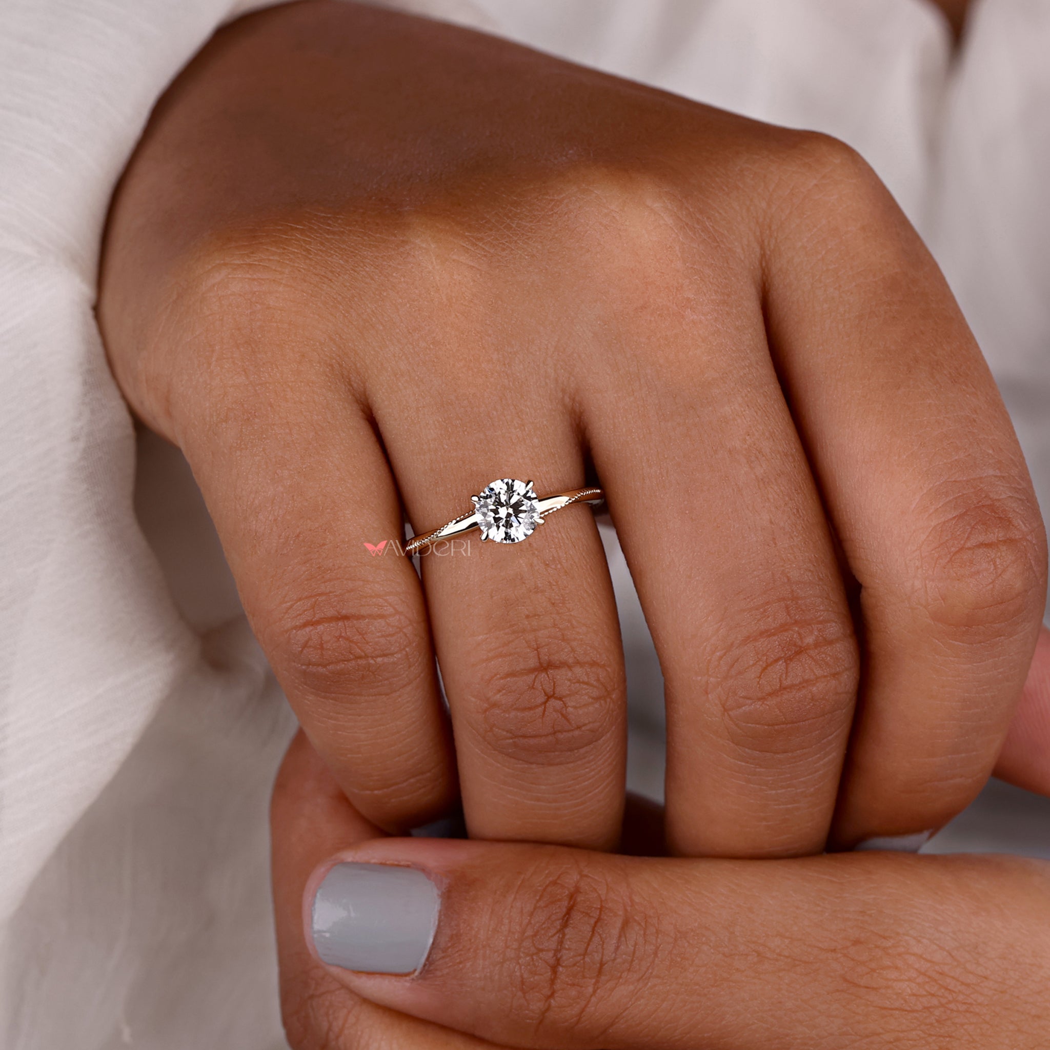 Milgrain solitaire engagement ring with a lab grown diamond and intricate handmade jewelry craftsmanship.
