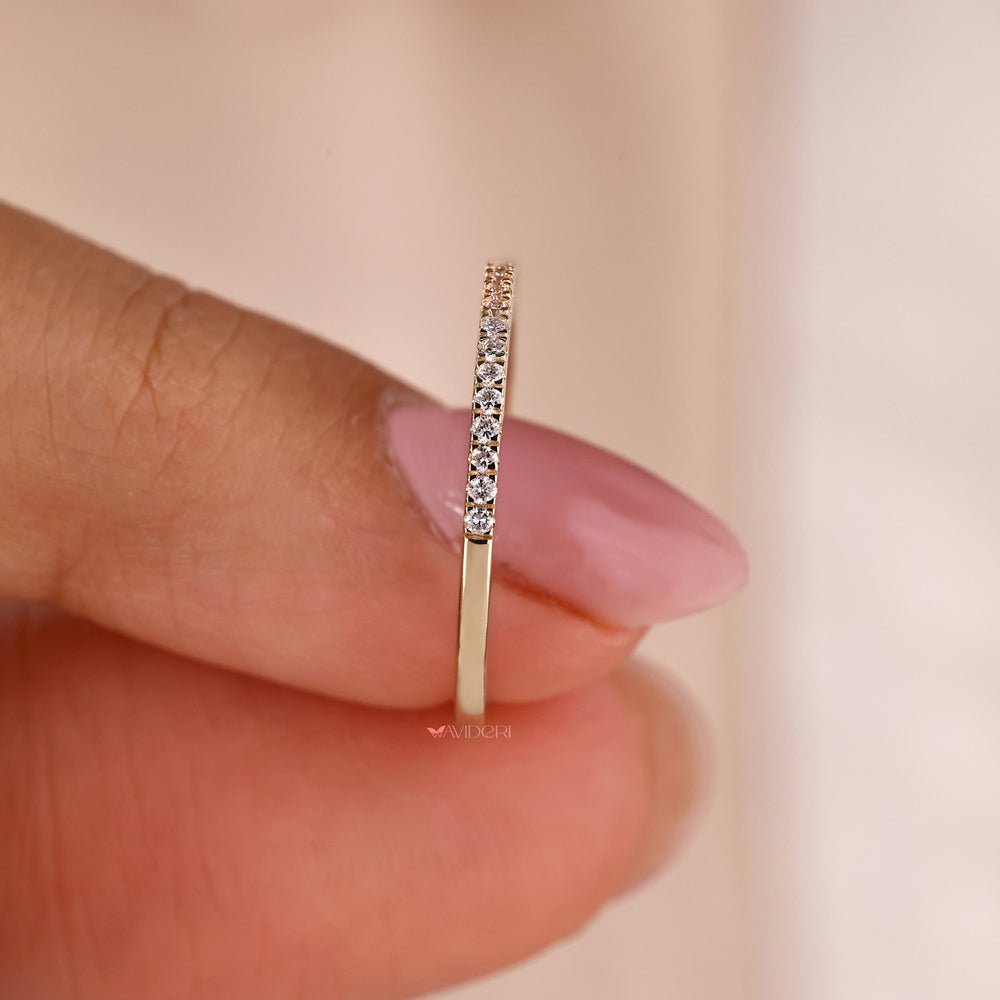 A luxurious yellow gold wedding band with diamonds intricately set in a micro pave design.

