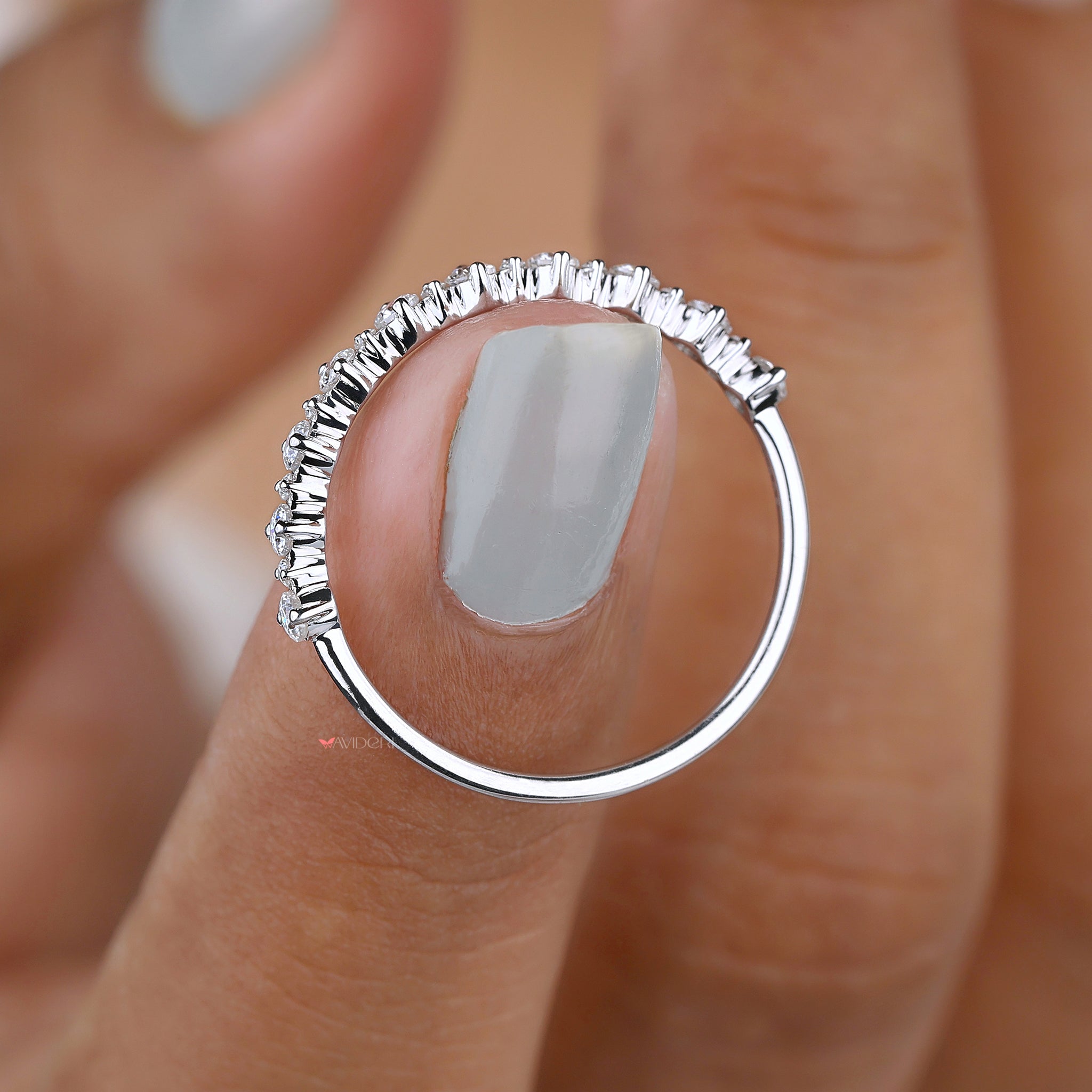 Round moissanite prong set half eternity band.
