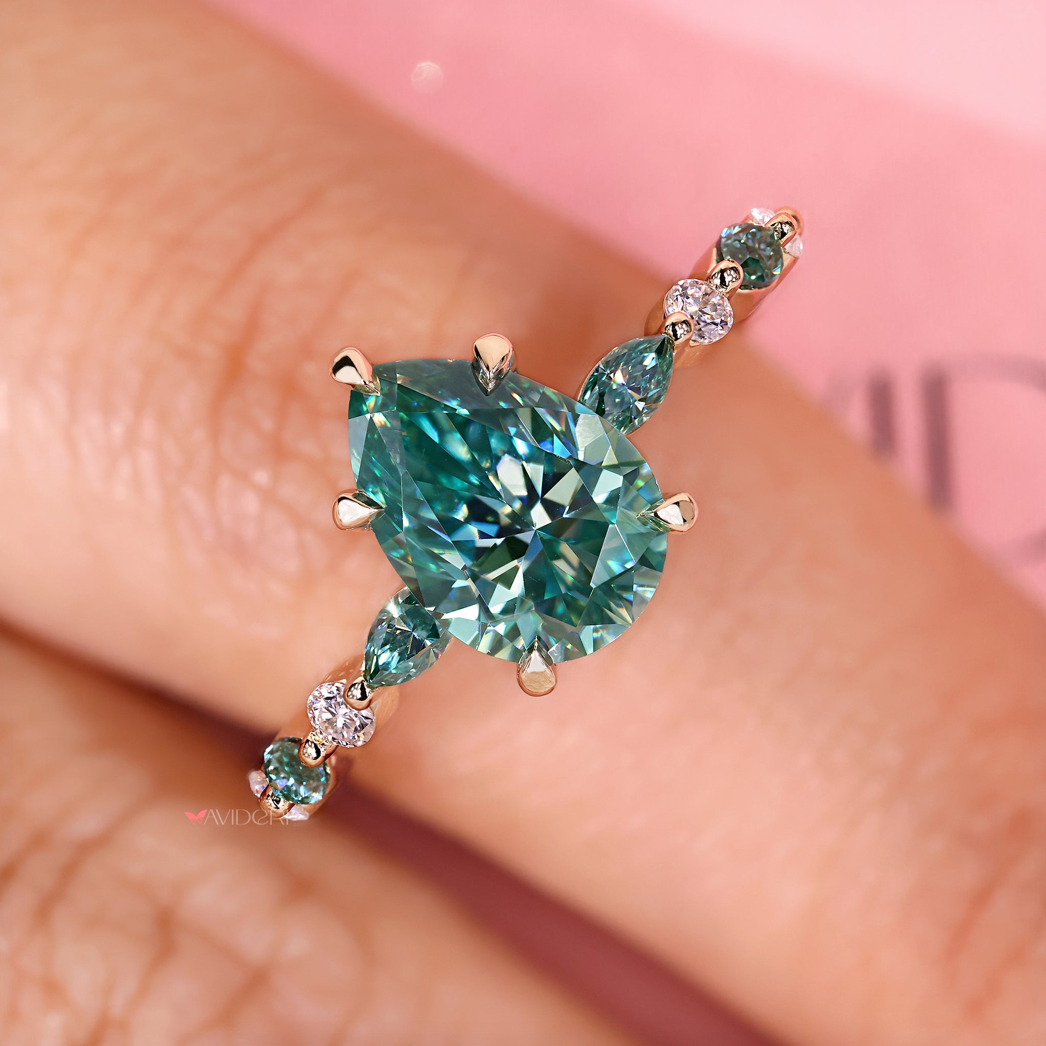 Pear cut ring with marquise side stones.
