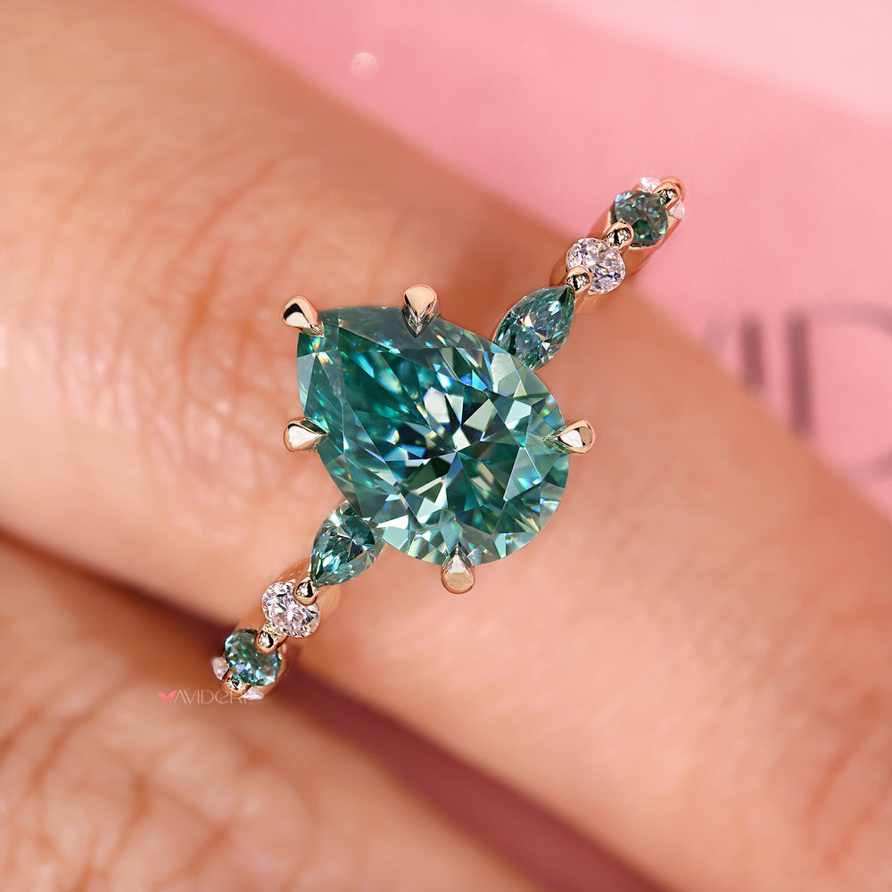 Pear cut ring with marquise side stones.
