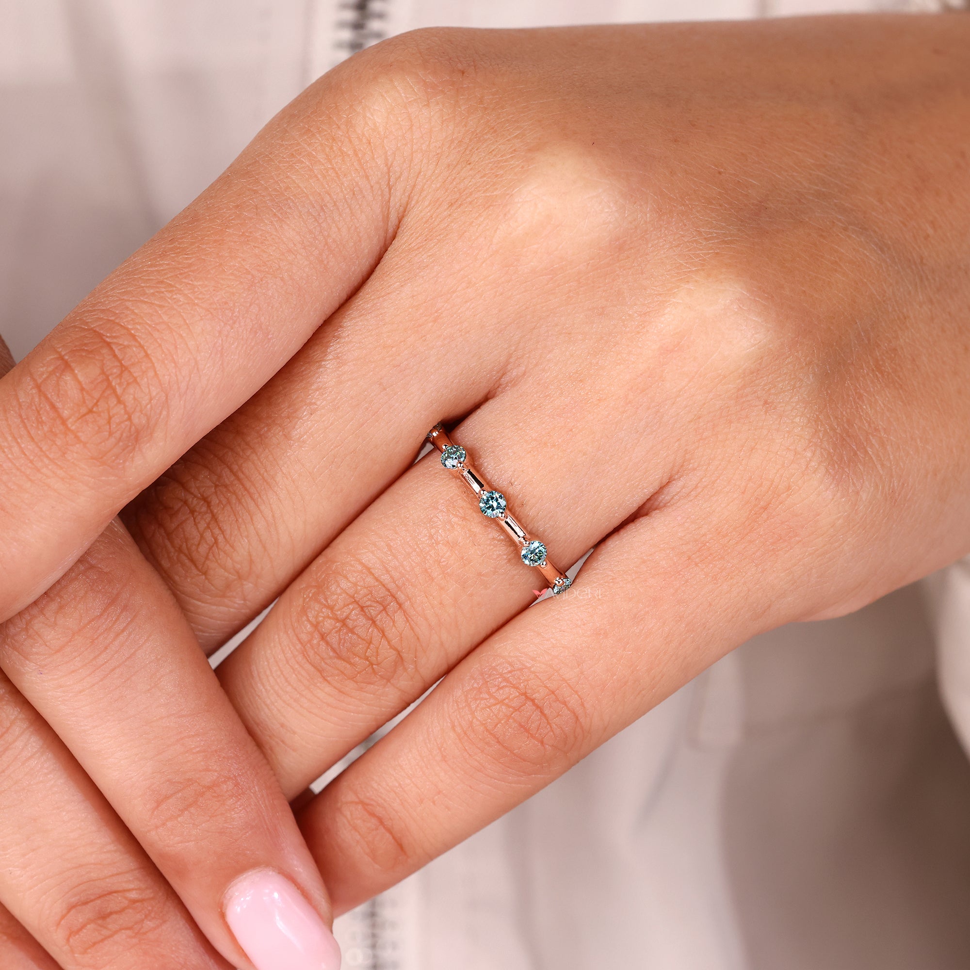 Distance pave set band creates visual interest with spaced stones for unique shine.