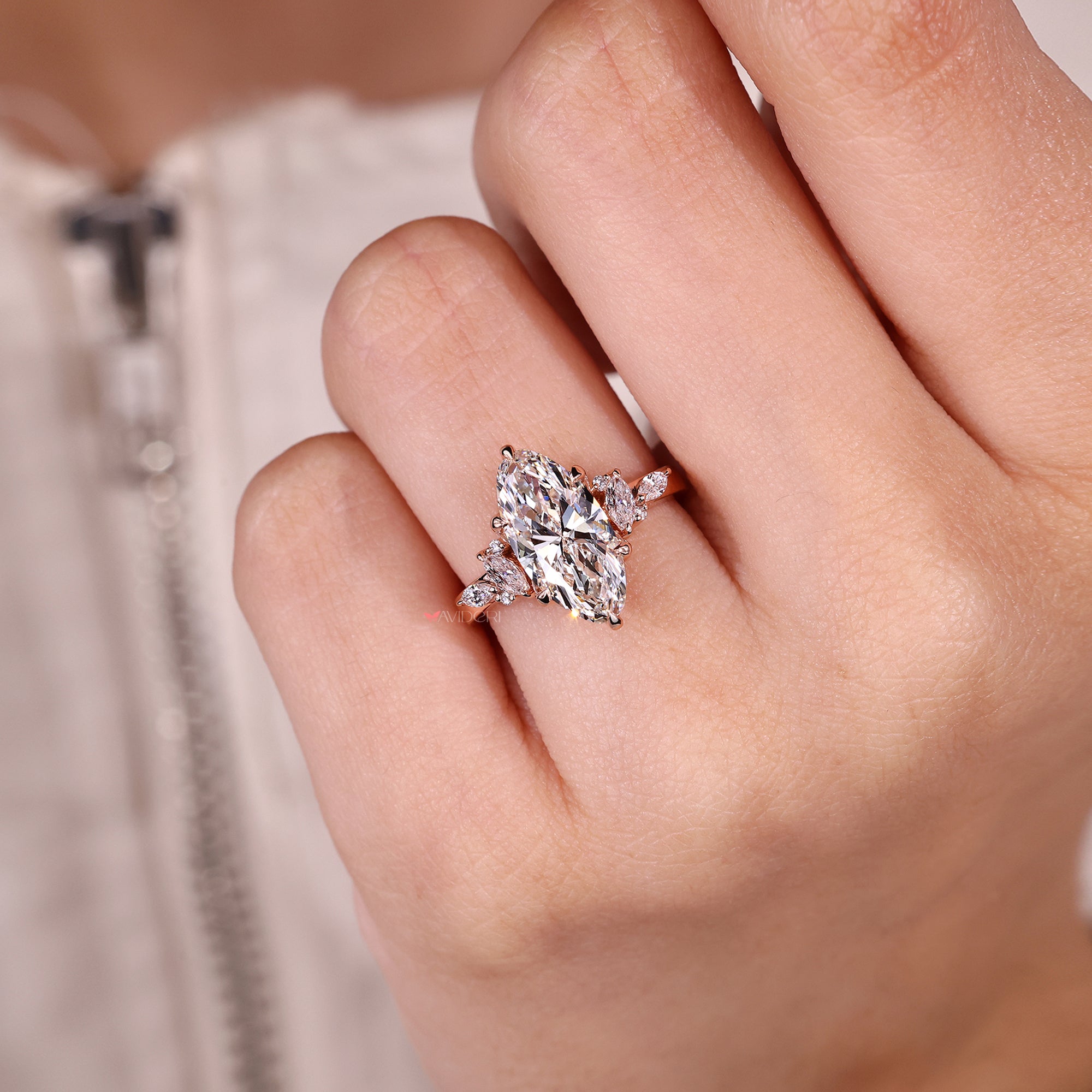 Moval diamond ring with marquise side stones.
