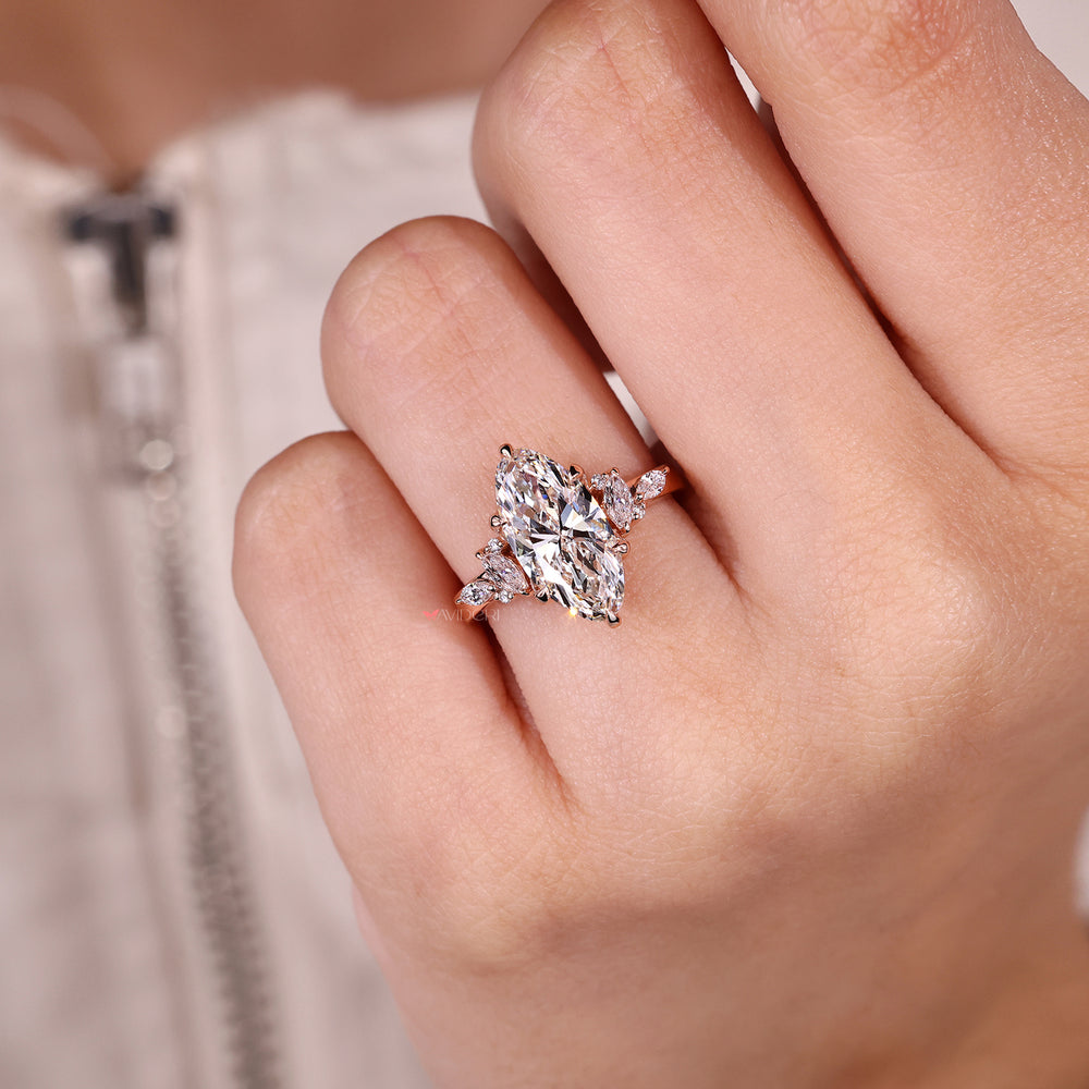 Moval diamond ring with marquise side stones.
