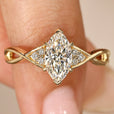 Marquise diamond ring with round side stones.
