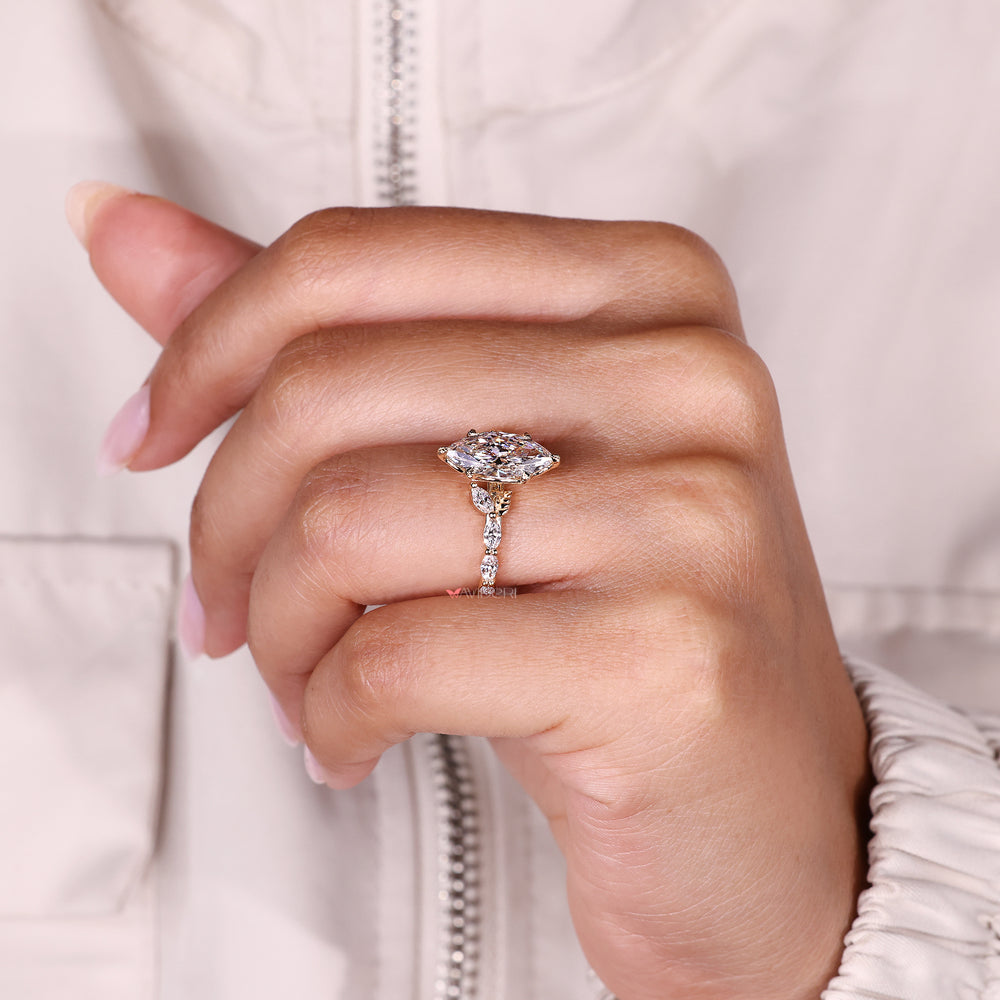 Marquise diamond ring with cathedral setting.
