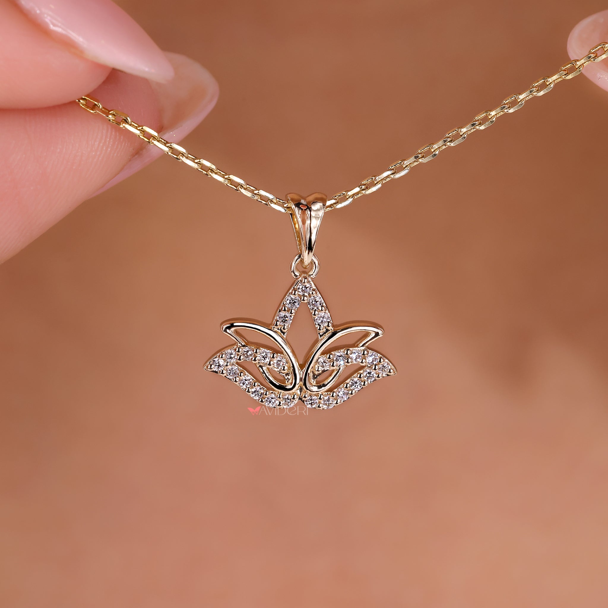 The gold lotus pendant brings warmth and elegance to any outfit.