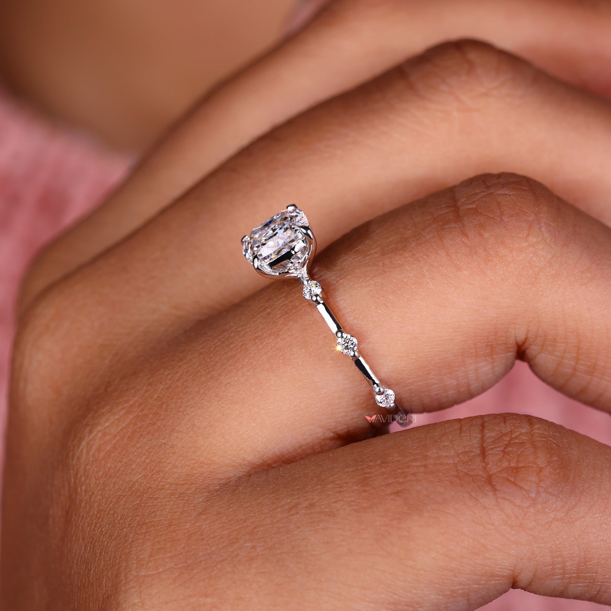 White gold cushion cut engagement ring with a claw setting and handmade jewelry craftsmanship for a timeless design.

