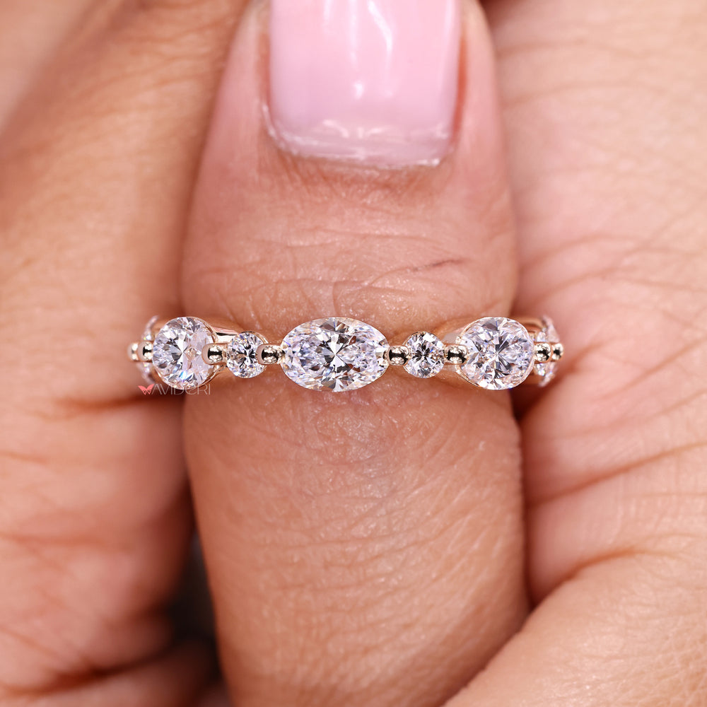 Oval round diamond band with prong setting style.
