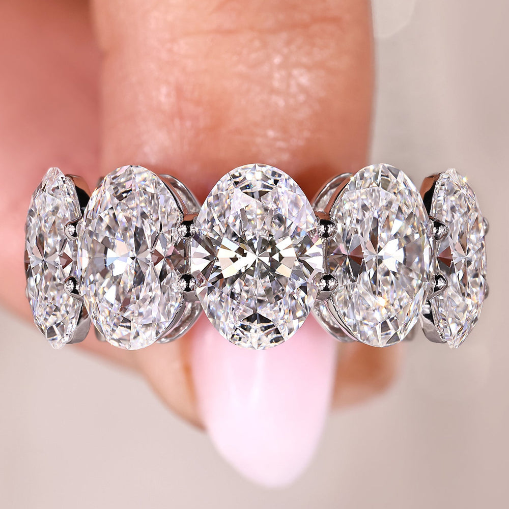 Oval cut diamond band in white gold.