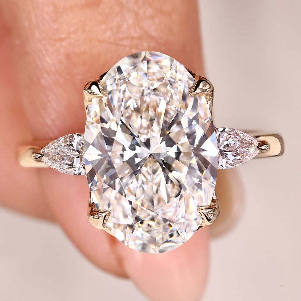 Oval cut diamond ring with pear side stones.
