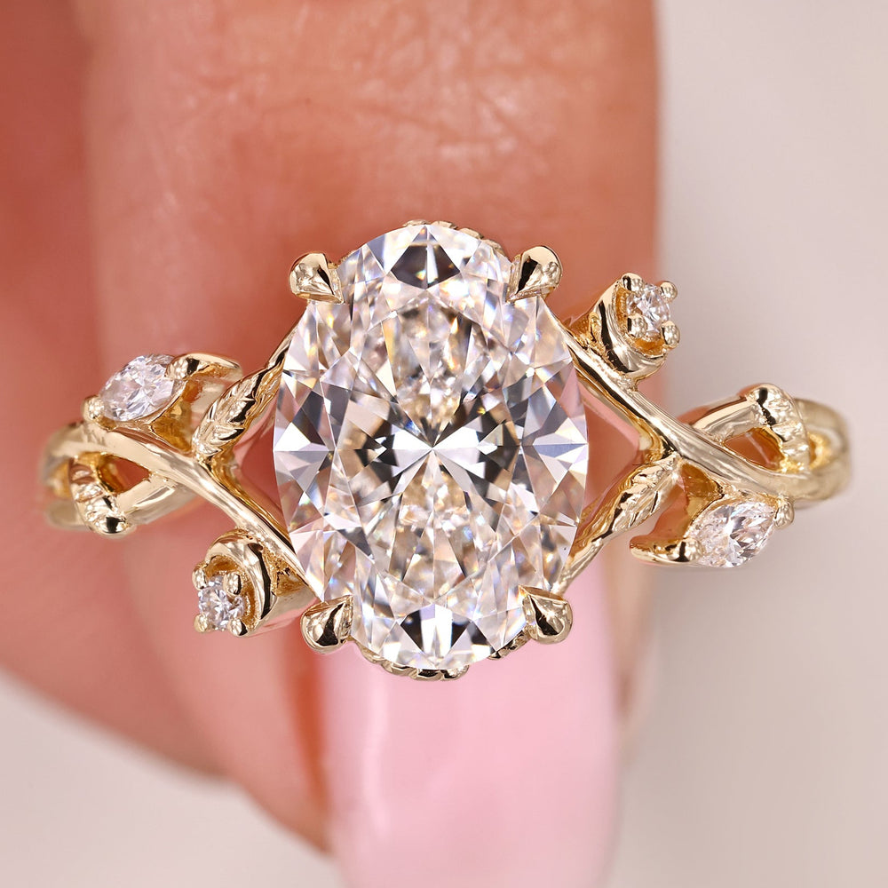 Oval Cut Diamond Ring with Marquise Side Stones in Yellow Gold.