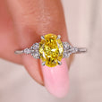 Oval cut yellow diamond ring with marquise and round side stones.