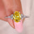 Oval cut yellow diamond ring with marquise and round side stones.