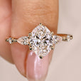Oval cut diamond ring with pear round side stones.
