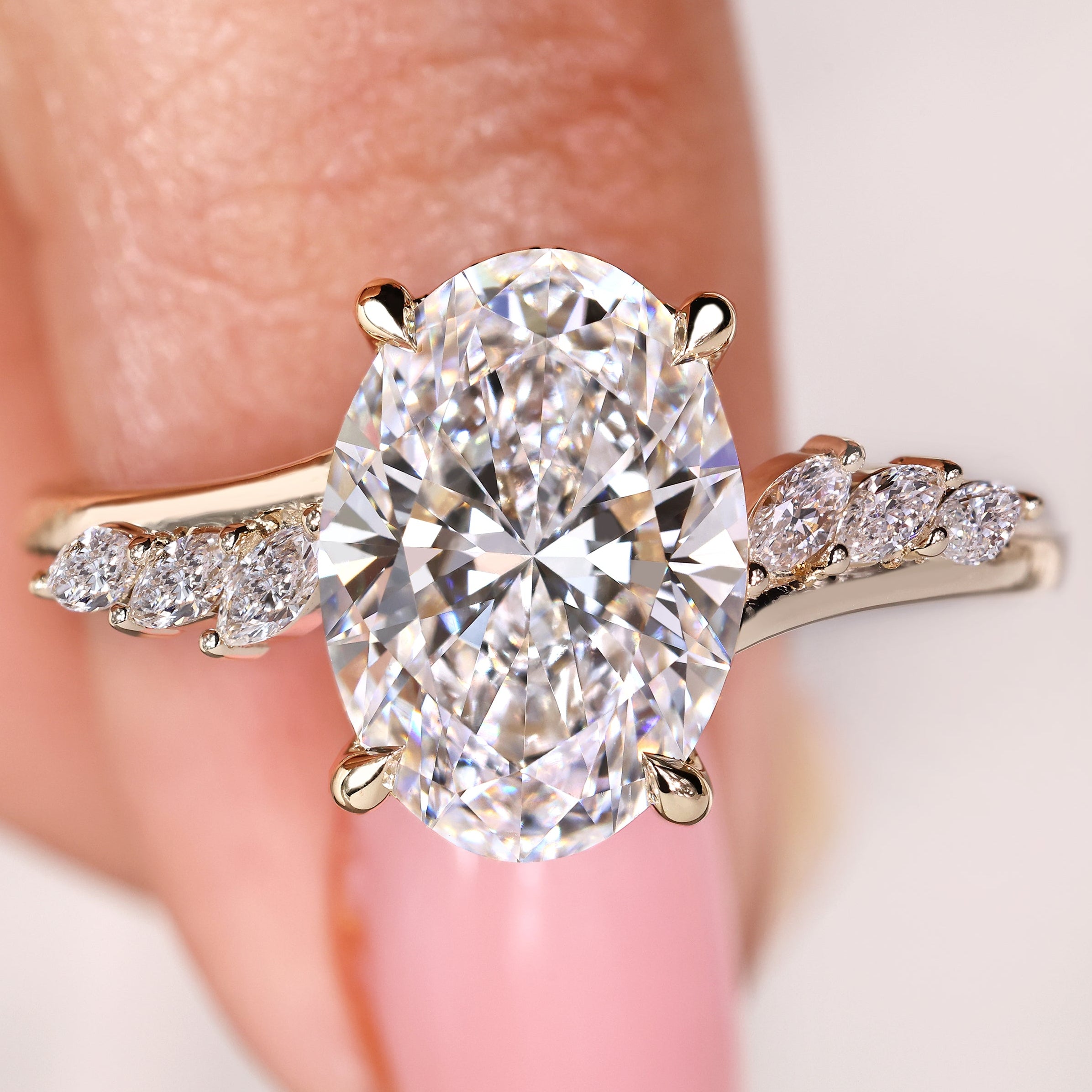 Oval cut diamond ring with marquise and round side stones
