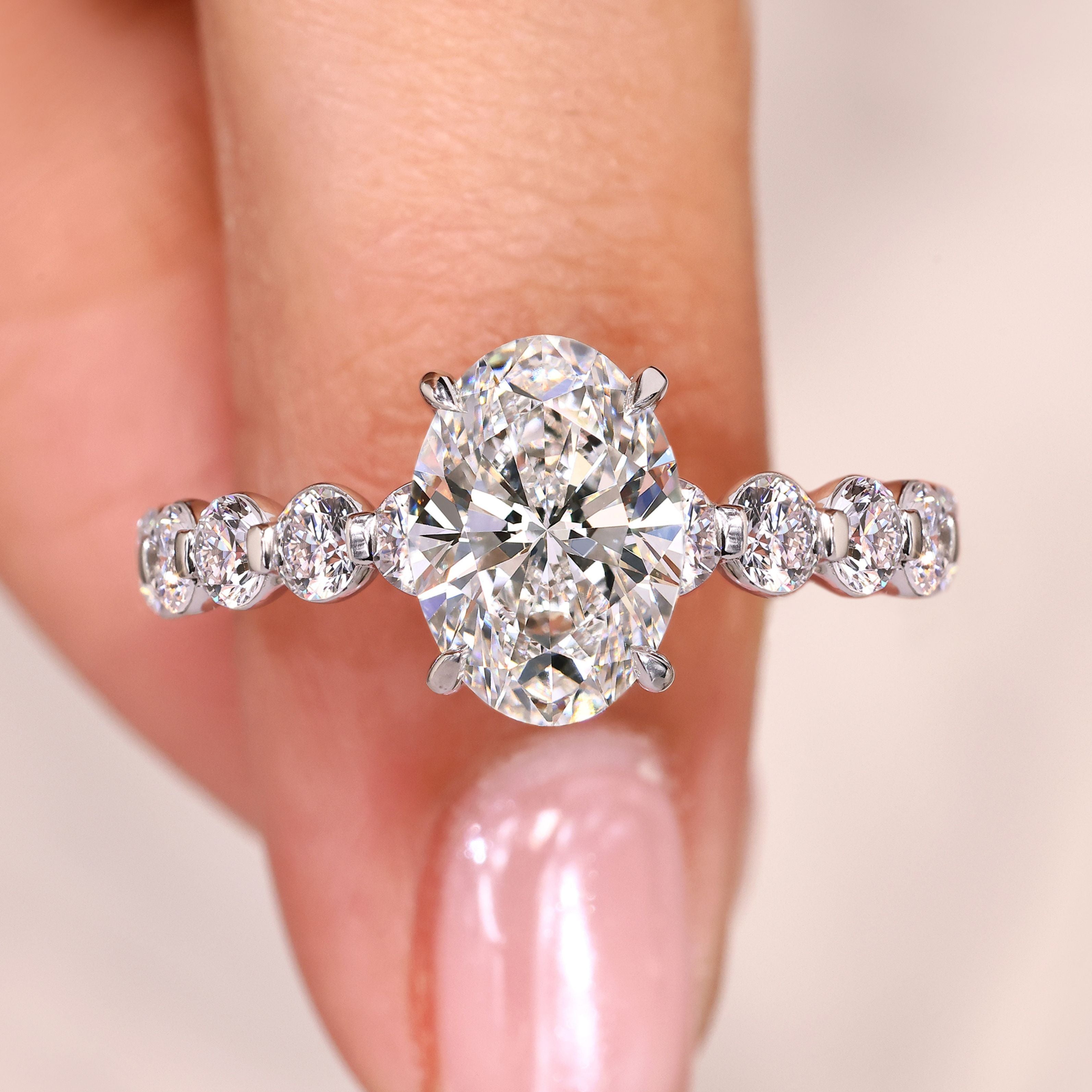 Oval cut diamond ring pave style with round stones.
