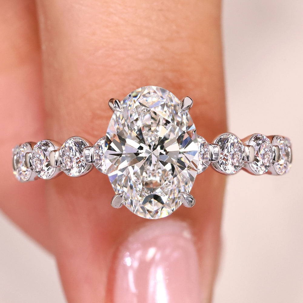 Oval cut diamond ring pave style with round stones.
