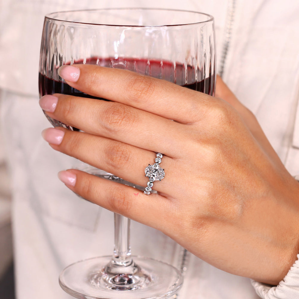 Oval diamond ring with four claw prong setting.
