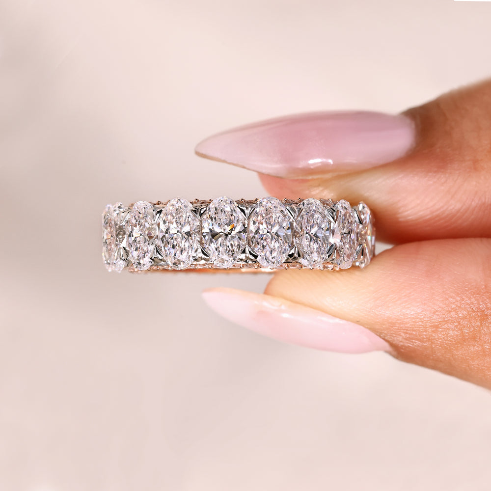 Oval band with heart prong and round diamonds.
