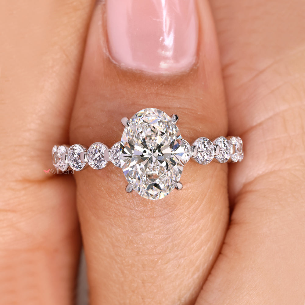 Oval cut ring with round pave diamond style.
