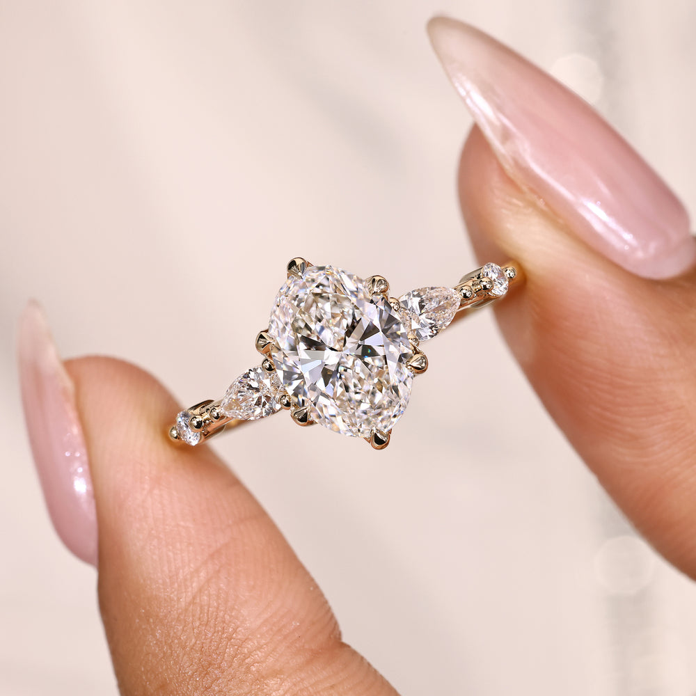 Five stone oval ring with pear round diamonds.
