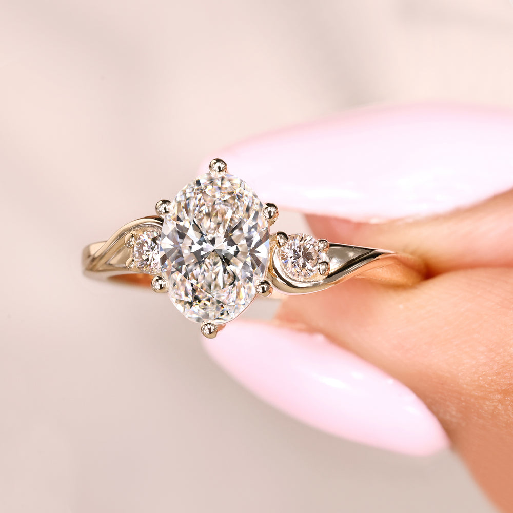 Oval cut diamond ring with three stone style design
