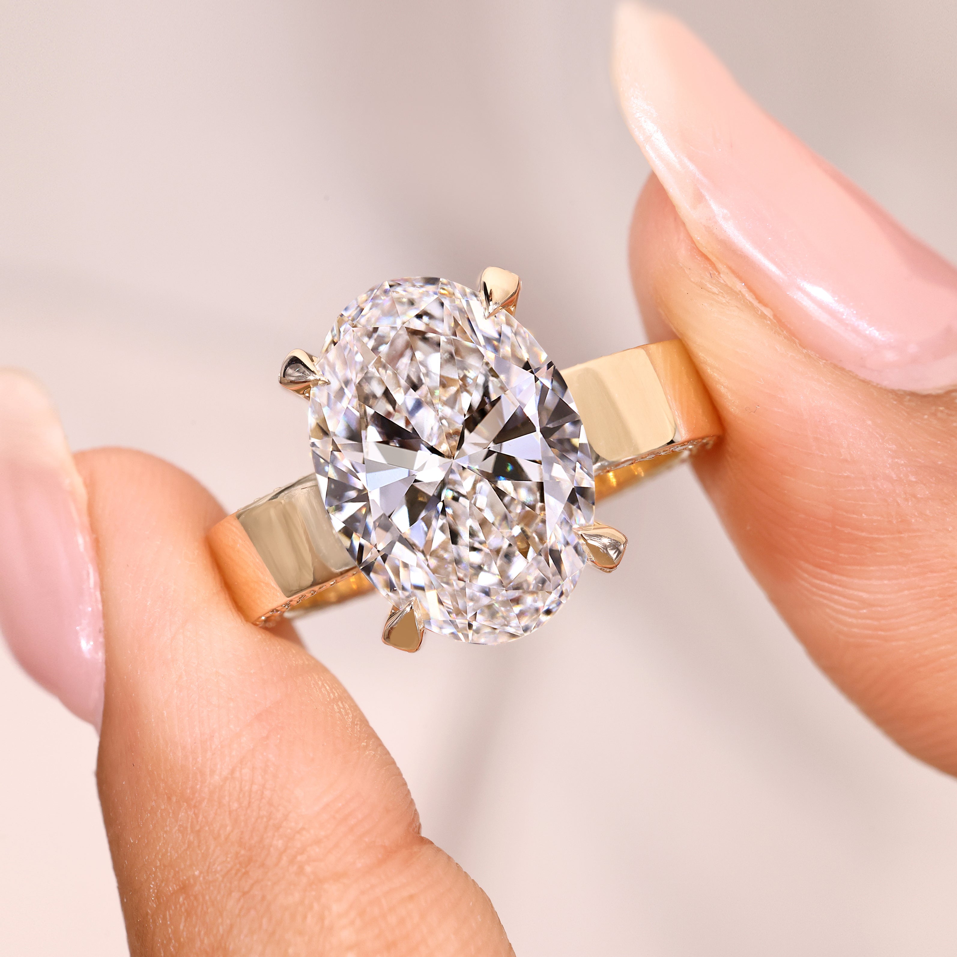 Oval ring with claw prong and pave setting.
