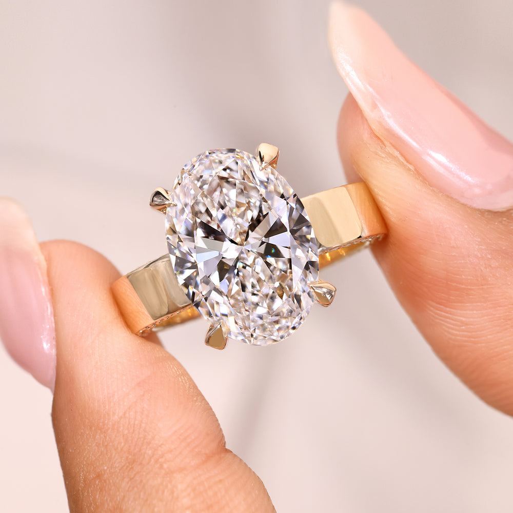 Oval ring with claw prong and pave setting.
