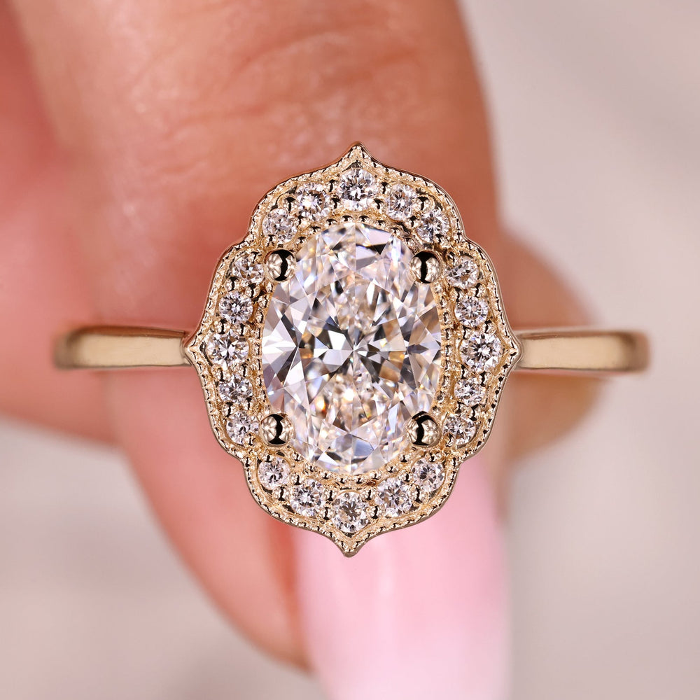 Oval diamond engagement ring with round halo setting.