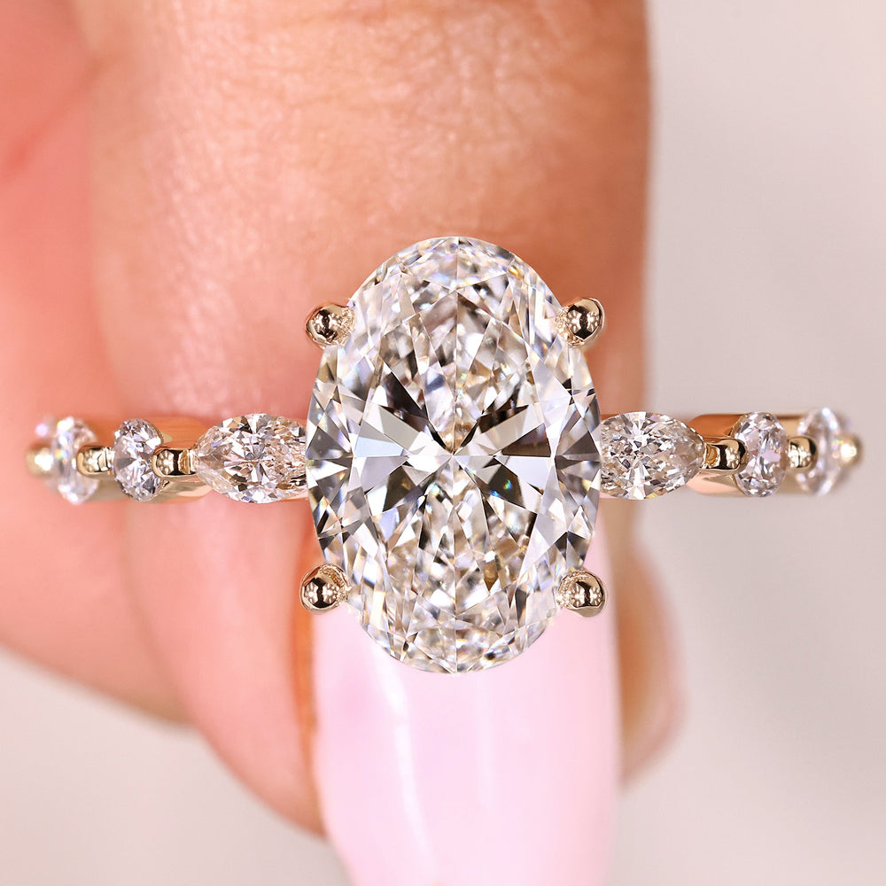 Oval diamond ring with shared prong pave side stones

