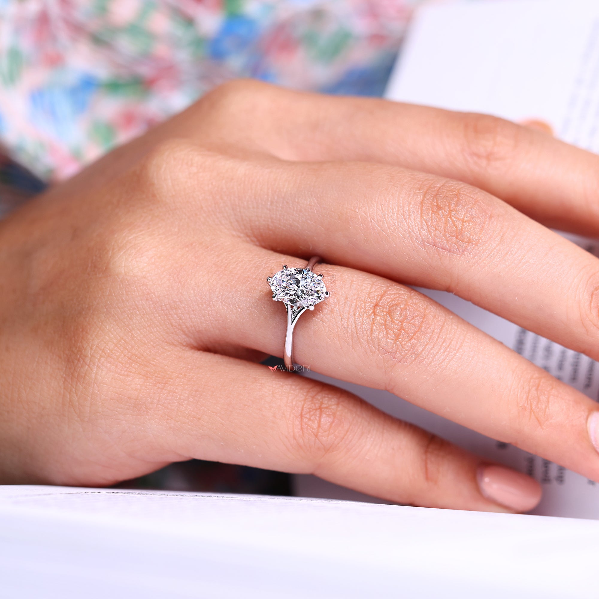 Oval diamond solitaire ring featuring a split shank design.