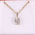 Oval solitaire pendant with 4 claw prong setting in yellow gold.