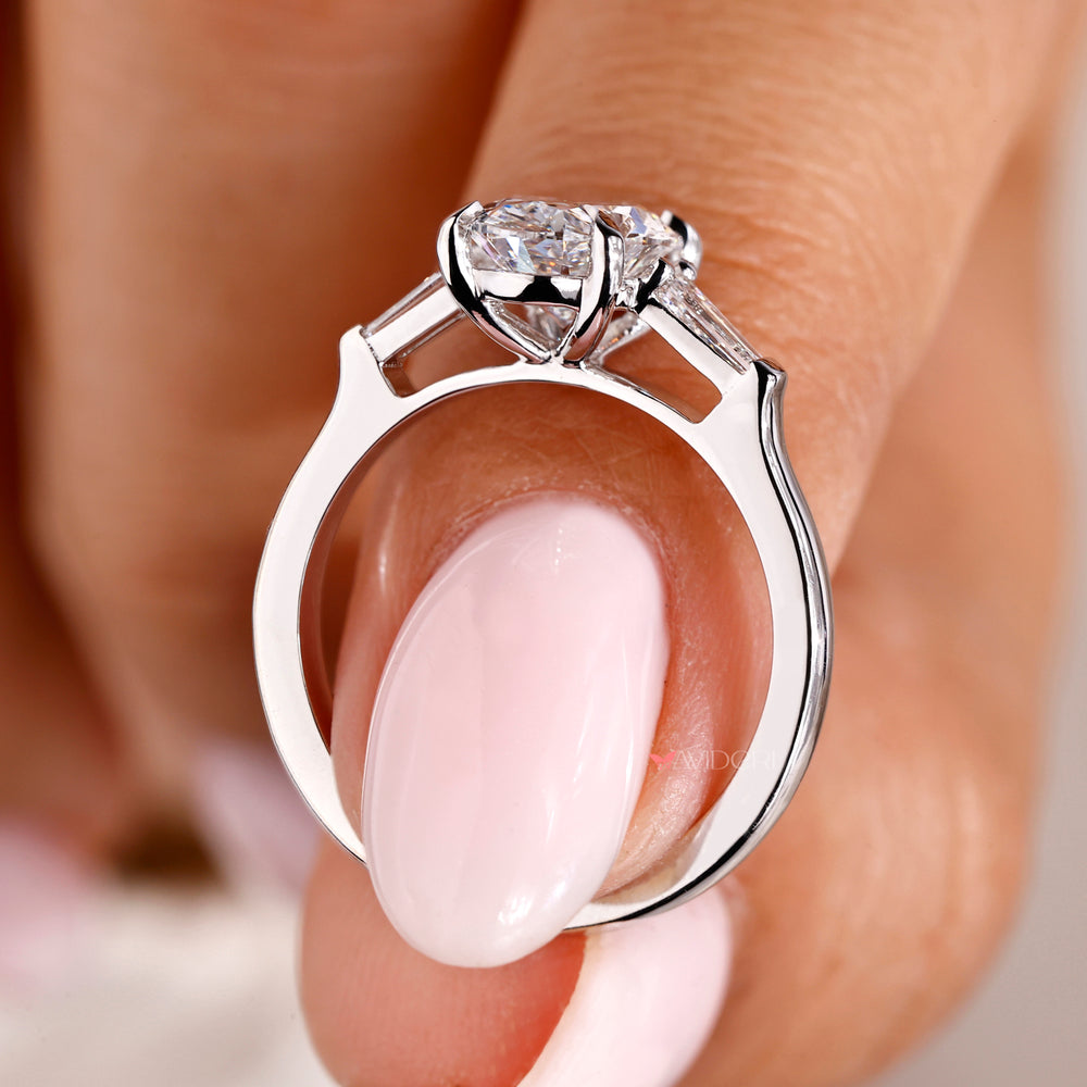 A white gold ring featuring a stunning oval shaped engagement design.
