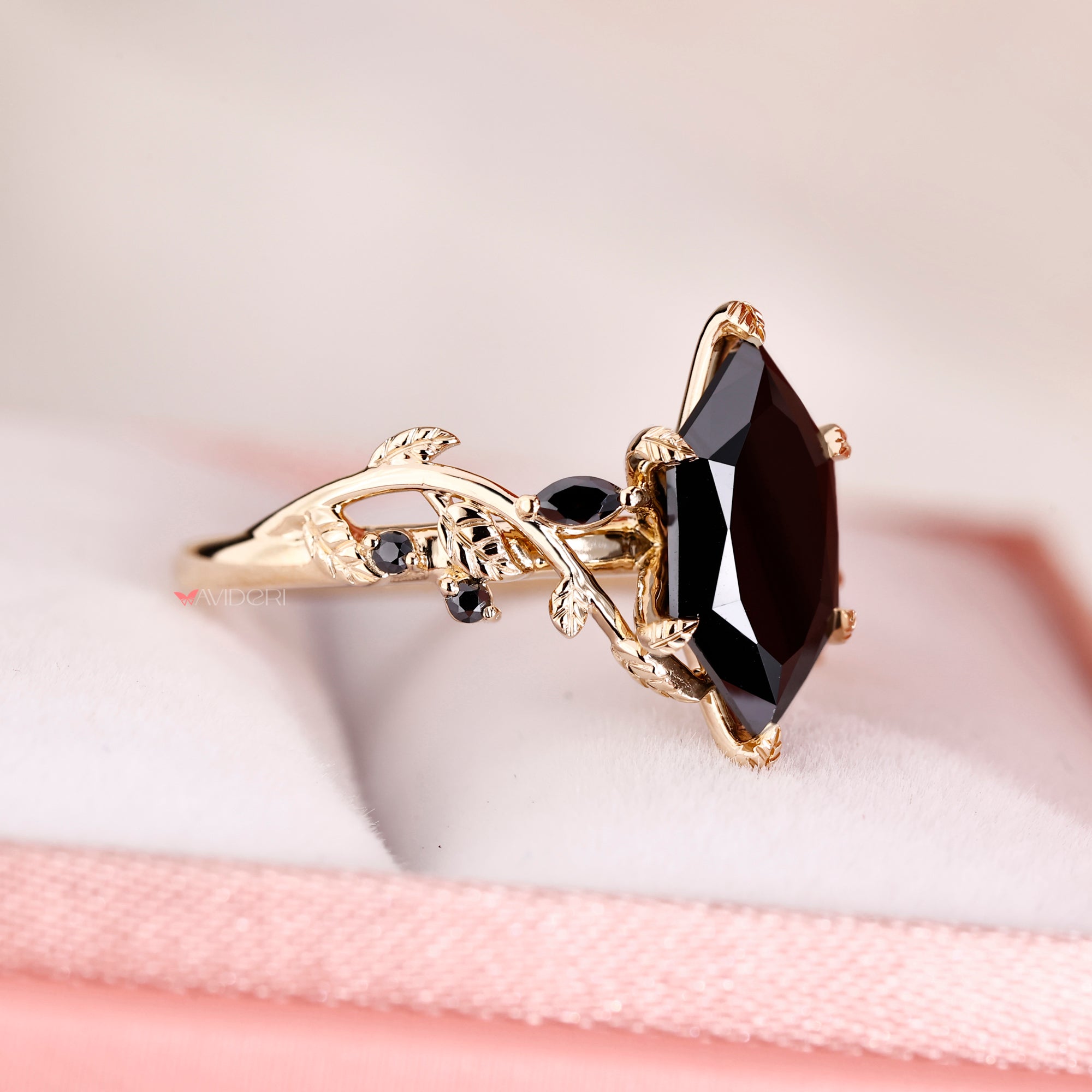 Marquise and round side stone in yellow gold engagement ring.