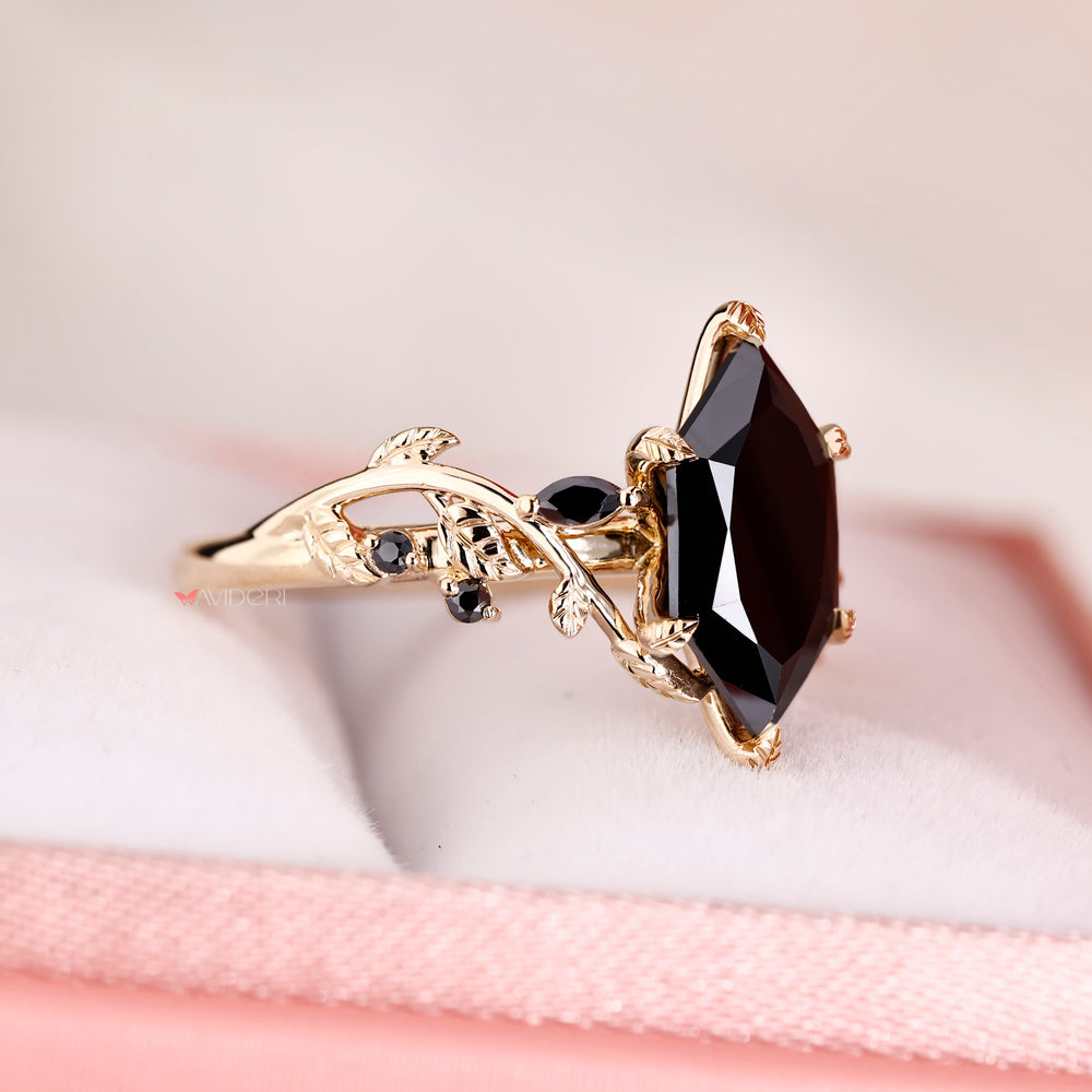 Marquise and round side stone in yellow gold engagement ring.