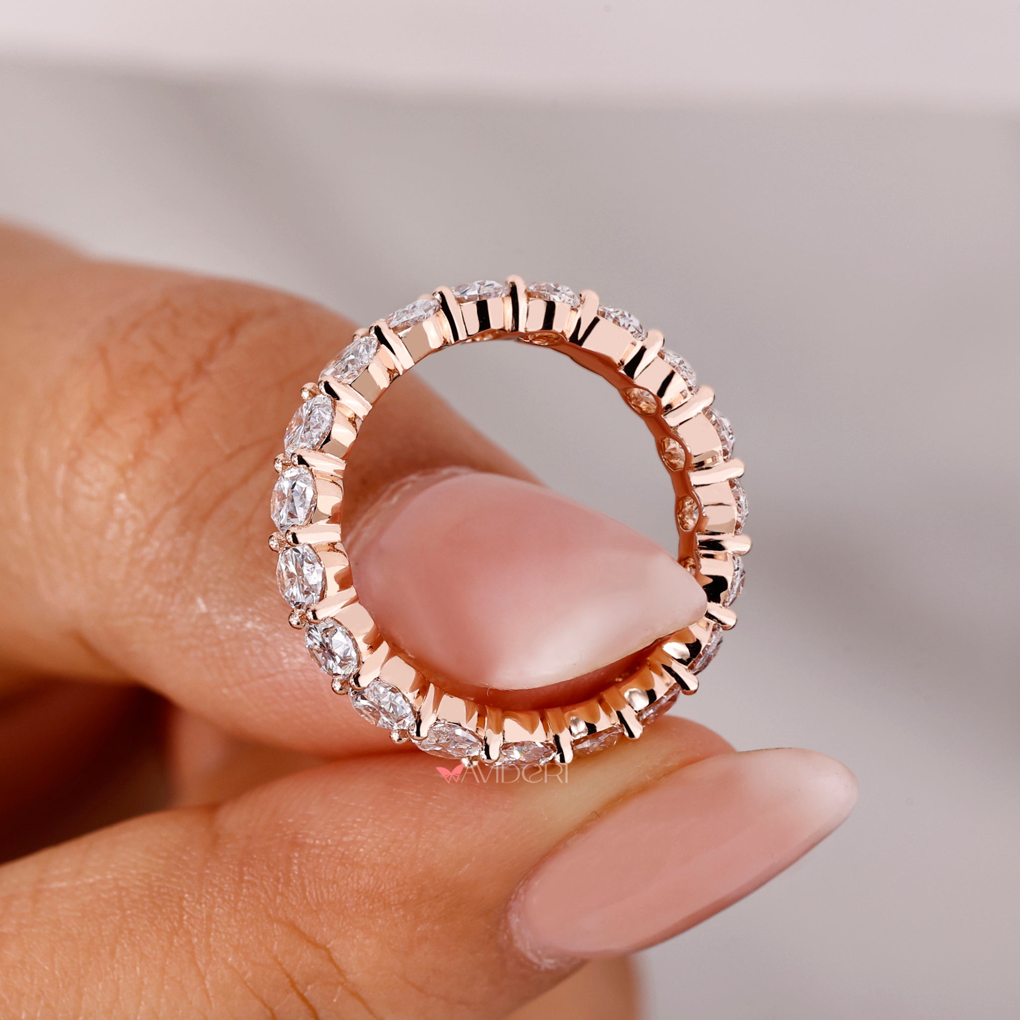 Beautiful oval diamond eternity band showcasing an oval brilliant diamond in a handmade setting.
