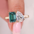 Pear and emerald cut ring in yellow gold cathedral setting.