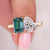 Pear and emerald cut ring in yellow gold cathedral setting.