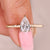 Pear cut diamond ring in minimalist solitaire style.