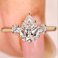 Pear cut lab grown diamond ring with round side stones
