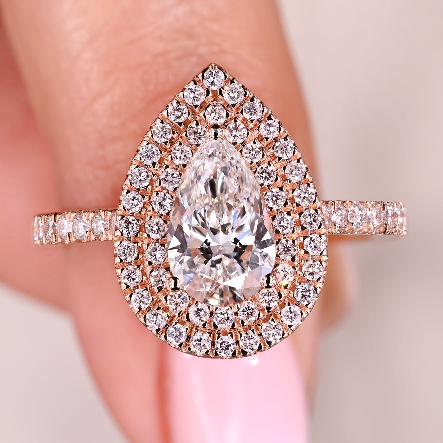 Pear diamond engagement ring with rose gold band.