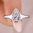 Pear cut diamond engagement ring with a tapered shank design.