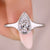 Pear cut diamond engagement ring with a tapered shank design.