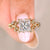 Princess cut diamond ring with marquise side stones.
