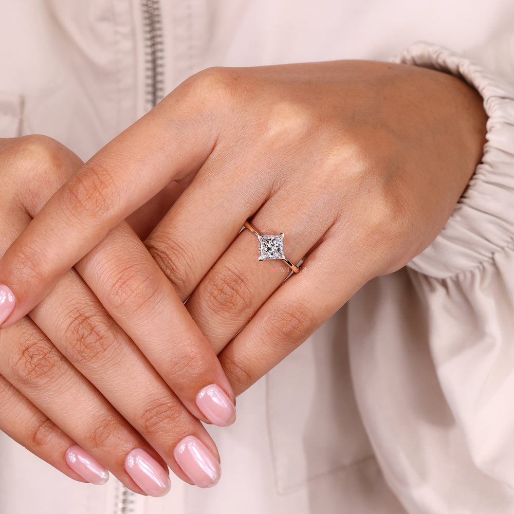 Princess cut solitaire ring with v prong setting.
