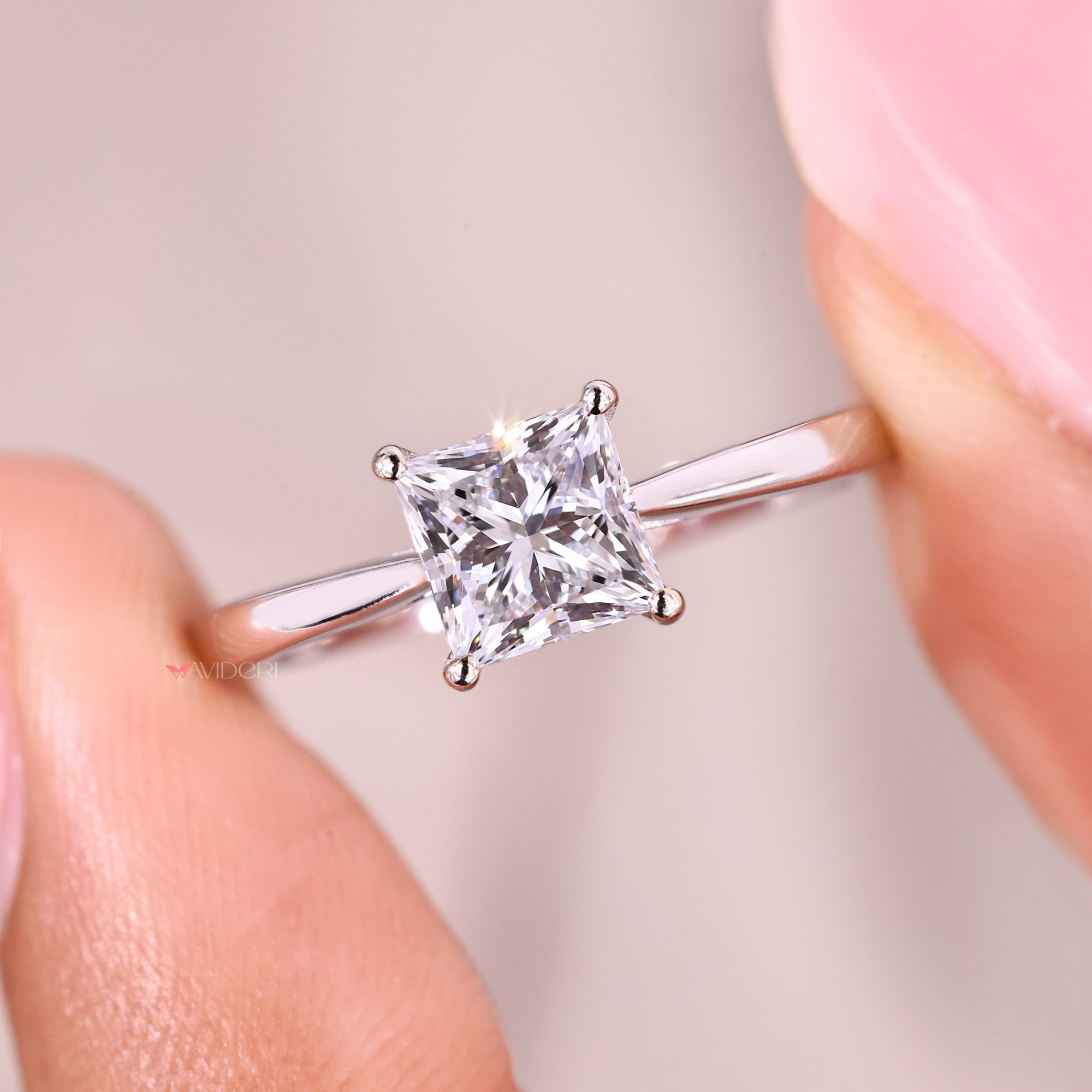 Princess cut diamond ring featuring secure four prong setting.
