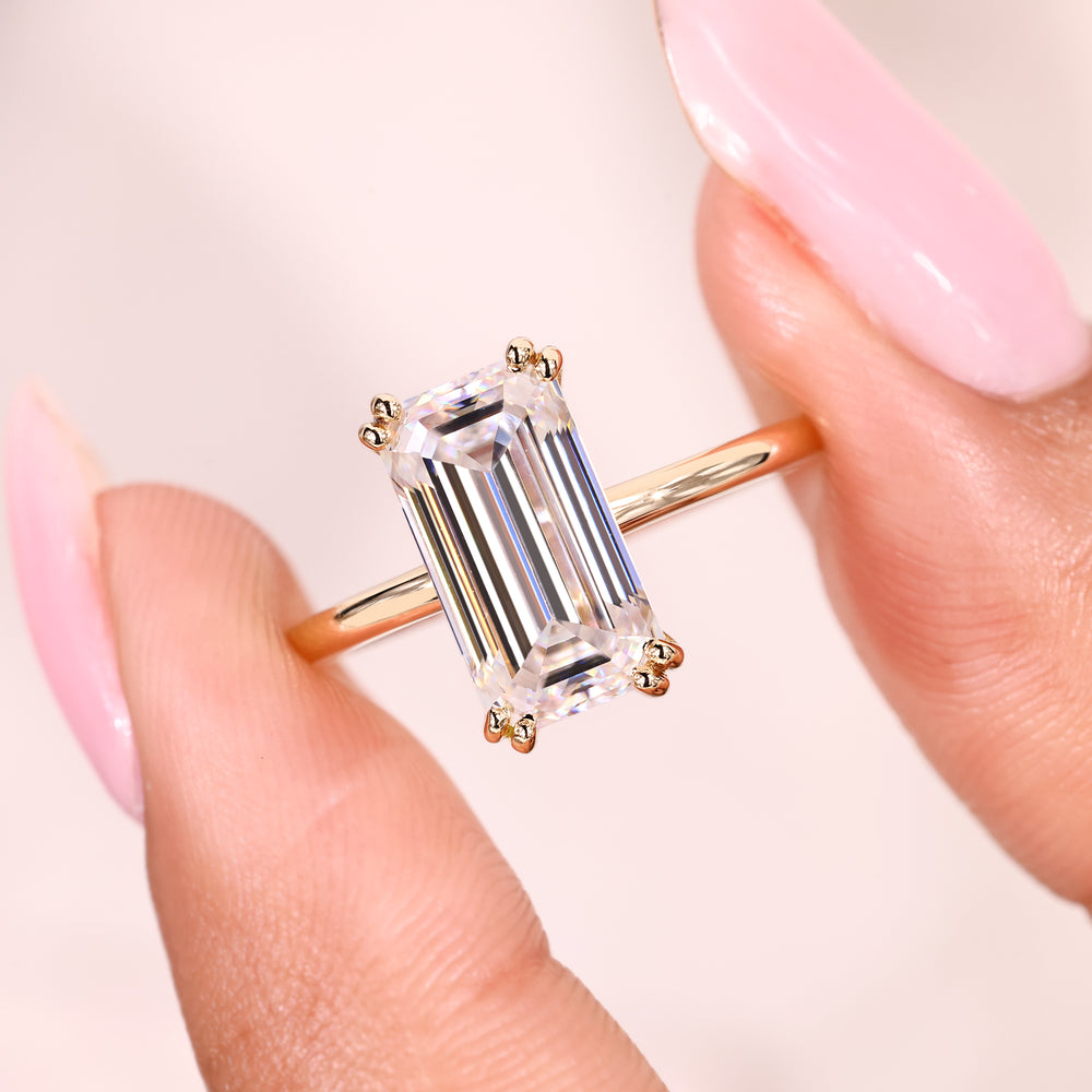 Minimal emerald cut moissanite ring design.

