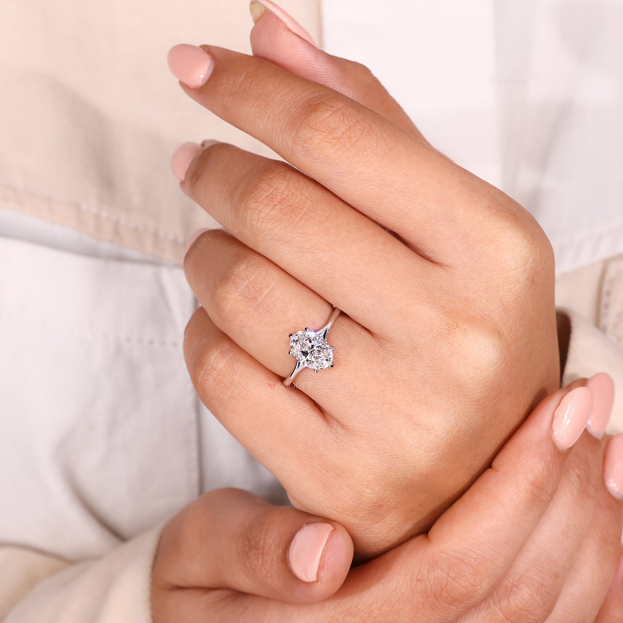 Platinum look diamond ring with solitaire oval cut.
